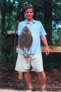 Chris Beard, of Wilmington, with a 21", 4 lb. flounder caught on the rocks at Masonboro using a live finger mullet on a Carolina rig.