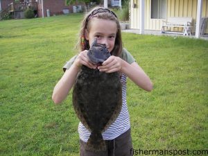 Sara Lucas (age 10), from Hampstead, NC, with a 4 lb. flounder she hooked on a Gulp bait at the Washington Acres boat ramp while fishing with her father, Jeff. Photo courtesy of East Coast Sports.