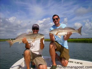 Gary Hurley and Max Gaspeny cradle the results of a double hookup on over-slot redfish that fell for Gulp Pogies in a creek near South Topsail. They were fishing with Capt. Mike Pedersen of No Excuses Charters out of Wrightsville Beach.