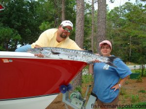 Kim Dudley, of Fayetteville, NC, with a 16.5 lb. barracuda she hooked on an artificial ribbonfish at Frying Pan Tower with her husband Wayne.