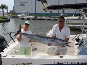 Doris Crocker, of Smithfield, NC, with a 58.5 lb. wahoo she hooked on a live bait and king mackerel tackle and fought for 45 minutes.  She was fishing with her son Don aboard the "Summer Headquarters."