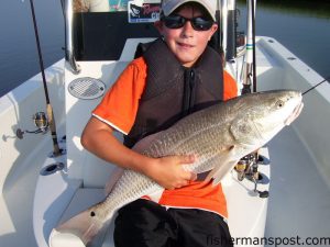 Logan Hislop, from VA, with a 31" red drum he caught while fishing with Capt. Jeff Cronk of FishN4Life Charters out of Swansboro.