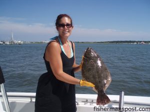 Trudi Rast, from Goldsboro, NC, with a citation flounder caught near Swansboro aboard the "Season Ticket." The fish fell for a Carolina-rigged finger mullet.