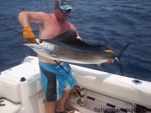 Kerry Gardner, from Newport, NC, releasing a sailfish caught aboard his brother Bryan's boat "Plan Sea" by their other brother Jay. They hooked the sail near the 14 Buoy along with 11 dolphin and a wahoo. Also aboard were Kerry's son Will and father Bill.