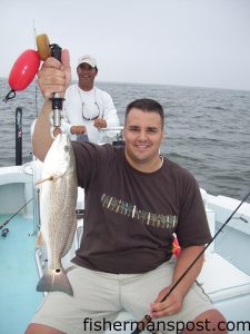Glen Burke, from OH, with a red drum caught at the Little River jetties on light tackle with a live shrimp. He was fishing with Capt. Patrick Kelly (at the helm) of Capt. Smiley's Fishing Charters out of North Myrtle Beach.