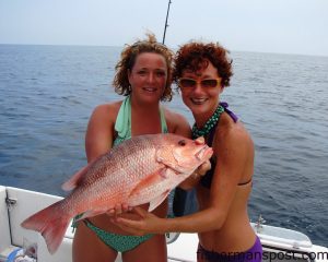 Deddi West and Amber Simmons with a red snapper caught on a live bait in 90' of water near the Junkyard.