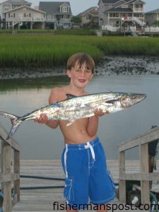 Dylan Matthews (age 7) with his first king mackerel. It was caught on a live pogy while fishing near Frying Pan Tower.
