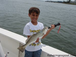 Sammy Shapiro, of VA, with a 4 lb. speckled trout he caught in the New River. The trout fell for a live shrimp under a Billy Bay float while he was fishing with Capt. Brent Banks of Specktacular Charters.