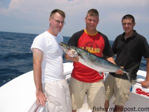 Matt Hasfken and Jeremy Markowski, of Baltimore, MD, and Abe Ortiz of Houston, TX, with the 19 lb. king mackerel that took first place in the 5th annual OBSFC Take the Troops Fishing Day, held August 9th. Jeremy caught the king while the Marines were fishing aboard the "Mister Stanman" with Capt. Stan Jarusinski.