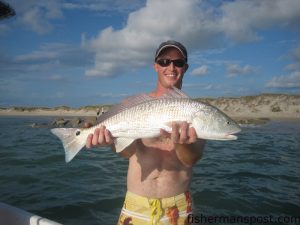 Dan McDonald with a 25" redfish caught on a large, live greentail shrimp at the Cape Lookout rock jetty.
