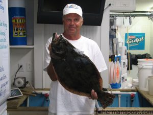Ray Lamb, of Chasin Tails Outdoors, with an 8.5 lb. flounder caught on a Gulp shrimp under a popping cork in 2' of water near Morehead City.