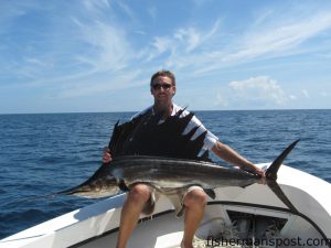 Capt. Brian Kelly, of Ocean Isle Beach, with a sailfish caught and released around 18 miles off Holden Beach. The sail fell for a dead cigar minnow under a pink Blue Water Candy skirt.