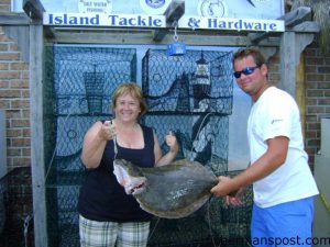 Jo Ann with a 9 lb. flounder that fell for a live 6" mullet in Snow's Cut while she was fishing with Capt. John Batson of Batson Charter Boats. Photo courtesy of Island Tackle and Hardware.