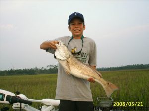 Connor Pollock (age 11), from Jacksonville, NC, with an over-slot red drum caught and released on a Redfish Magic spinnerbait while fishing an early rising tide in a creek near Camp LeJeune.