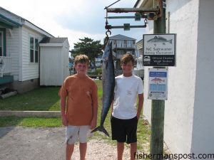 William Adams and Scott Ellington, from Burlington, NC, with a 27.5 lb. wahoo caught 12 miles off Beaufort Inlet on a dead cigar minnow under a King Duster while they were fishing aboard an 18' Grady White. Weighed in at Chasin Tails Outdoors.