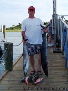 John Crowe, from Holly Springs, NC, with a catch including beeliners, a scamp grouper, and a 33 lb. king mackerel he hooked while light-lining 36 miles off Beaufort Inlet in 105' aboard the Carolina Princess.