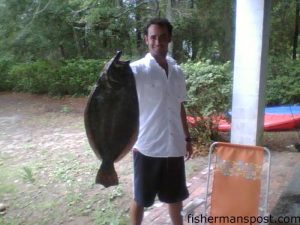 Steve Steele with a 28" flounder caught in Davis Canal off a dock. The flounder fell for a live finger mullet.