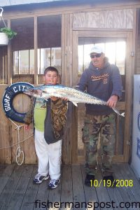 Brandon White (age 10) and his father Don, of Surf City, with Brandon's first king weighing in at 17.5 lbs. and caught using live bait on a king rig.