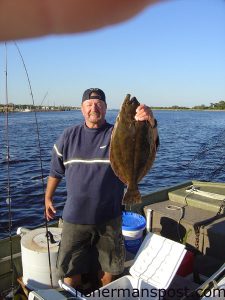 Harry "Harry G" Gierszewski, of Carolina Beach, with a 27", 7 lb. flounder he caught in Snow's Cut on a live finger mullet.