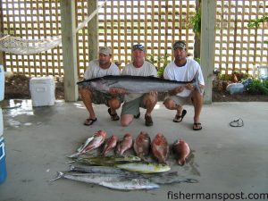 Toby Fulford, Dan Mason, and Tony Fulford with a 55 lb. wahoo, dolphin, red grouper and king mackerel they off caught Lockwood Folly Inlet aboard Mason's 20' Trophy "Gone Again."