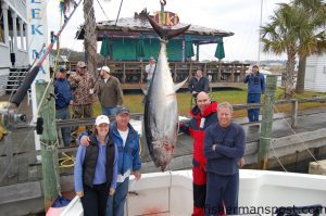 The crew of the “Fin Addict,” including Capt. Mark Chesnick, angler Matt Held, and leaderman Jim Hulin, with a 310 lb. giant bluefin tuna they caught offshore of Morehead City the Saturday after Thanksgiving. 