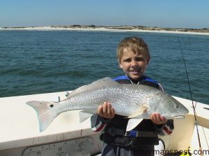 Hunter Beach (age 7), of Clayton, NC, with his first red drum. It was caught on a live finger mullet on the Bogue Inlet shoals while fishing with Capt. Rob Koraly of Sandbar Safari Charters out of Swansboro.
