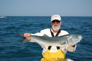 Billy Manger with a monster chopper bluefish around 13 lbs. that he hooked beneath a schools of feeding bonito while fishing near Diver's Rock with Capt. Jim Sabella.