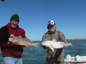 Bob Pickens, owner of the Harbor Light Guest House in Cape Carteret, and friend Wayne Veavers with two redfish caught and released off of Bear Island in the surf zone on white Gulp flukes on 1/4 oz. jigheads.
