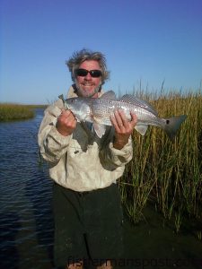 Clay Shields, from Scotts Hill, NC, with a slot red drum that fell for a 4" Molting Gulp shrimp in the marsh behind Fort Fisher.