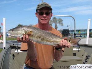 Tom Blevins, of Morehead City, with a 26" redfish caught on a Berkley Gulp in the marsh around Morehead City. Photo courtesy of Chasin' Tails Outdoors.