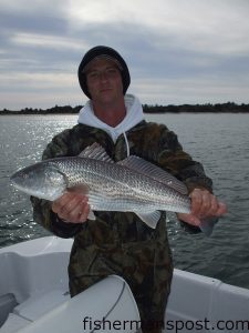 Mark Benson, from Wilmington, with a red drum he caught on cut mullet near Masonboro Inlet.