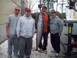 Cory Norville, Jared Grummert, Rick Jackson, and Mark Karoub, from New Bern, NC, with Jared's first wahoo, a 52 pounder that bit a ballyhoo under a pink sea witch inshore of the Swansboro Hole. Weighed at EJW Outdoors.