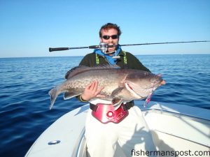 Chip Baker, of Wilmington, with a 40 lb. gag grouper he hooked while vertical jigging inshore of the Steeples with his father, Bizz Baker.