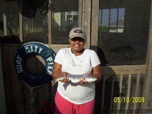 Taylor, from Clinton, N.C., with a gray trout she hooked while fishing from Surf City Pier.