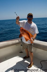 Mike Paul, from Greenville, NC, with a bigeye, an unusual bottomfish he hooked while deep dropping in 450' of water. He was fishing off Morehead City with Capt. Steve Henderson aboard the "Accord-ingly."
