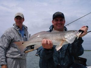 Brothers Win and Dave Edwards, from Kinston, NC, with one of many red drum they caught on spinning and fly tackle while fishing near Swansboro with Capt. Jeff Cronk of FishN4LIfe Charters.