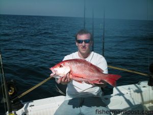 Daniel Raeburn, of Morehead City, with a genuine red snapper caught while offshore bottom fishing around 20 miles off Beaufort Inlet. The red fell for a squid.