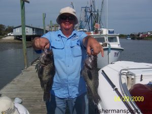 Mike Haggie, of Little River, SC, with a pair of fat black sea bass he hooked while bottom fishing offshore of Holden Beach with Capt. Keith Logan of Stand 'N Down Charters.
