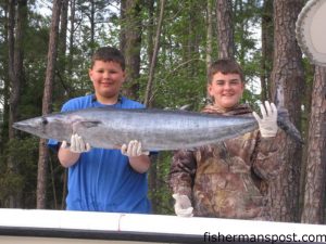 Austin Woody and Braeden Wright, from Southport, with Braeden's first wahoo. The 'hoo fell for a ballyhoo beneath a chartreuse/orange jet head between the Blackjack Hole and the 100/400 while fishing aboard Braeden's father Mike's 25' Contender "Spread M Wide."