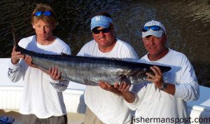 Trask Cunningham, Chris Critz, and Jeff Cunningham with a 60 lb. wahoo Jeff hooked at the Blackjack Hole on a mediuym ballyhoo behind a silver Mylar jet head. They were fishing out of Holden Beach aboard the "Critter."