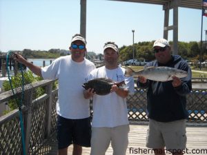 Brandon Sauls, Capt. Mark Stacy, and Capt. Mark Dickson with the winning 5 lb., 14 oz. speckled trout and 2 lb. 2 oz. flounder that earned them the top spot in Tripp and Austin's Backwater Battle for the second year in a row.