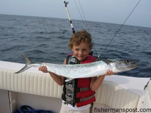 Charlie Truby (age 4), of Greensboro, NC, with his first king mackerel. The king fell for a red/black jethead in front of a ballyhoo while he was fishing at the Horseshoe with his father Chuck and uncle Henry Hare.