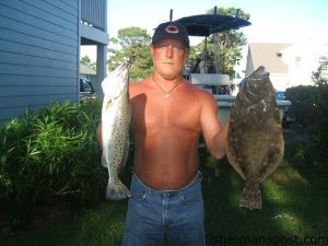 Lonnie Crawford, of Kure Beach, NC, with a 3 lb. speckled trout and a 4 lb. flounder that fell for live peanut pogies on Carolina rigs. He was fishing with his son Curtis in Carolina Beach Inlet.