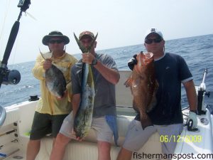 Joe Pain, Dan Howard, and Randy Martin, from Statesville, NC, with a triggerfish, a dolphin, and a red grouper they hooked while fishing near the Blackjack Hole with Capt. Keith Logan of Stand'N Down charters out of Holden Beach.