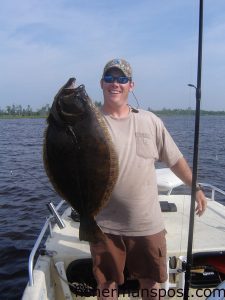 Kevin Hall, from Leland, NC, with a 9 lb., 7 oz. flounder he hooked in the Cape Fear River on a live pogy pinned to a jighead.