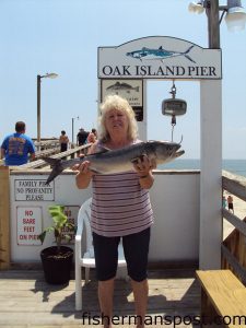 Judy Oxendine, of Oak Island, with an 8.1 lb. bluefish she hooked on a live grass shad from the Oak Island Pier.