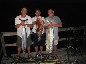 Gene Norris, Capt. Keith Logan, of Stand'N Down Charters out of Holden Beach, and Johnny Jones with a wahoo, a red grouper, and dolphin they hooked offshore of the Blackjack Hole.