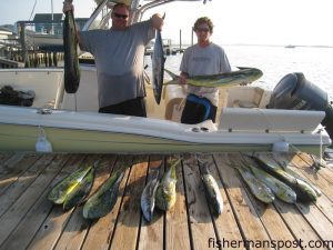 Lance Chambers and Jason Pippin with dolphin and king mackerel they hooked while trolling pink-skirted ballyhoo between the Nashville and the Normania with Capt. Tim Price.