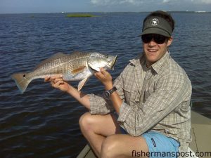 Jack Elmore, from Raleigh, with a 27" red drum that fell for a topwater plug behind Bald Head Island while he was fishing with his father John.