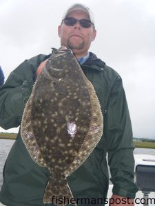 Ryan Pruitt, from Raleigh, NC, with a big summer flounder that fell for a 4" Gulp Pogy in 1' of water. He was fishing the Swansboro backwaters with Capt. Jeff Cronk of FishN4Life Charters.